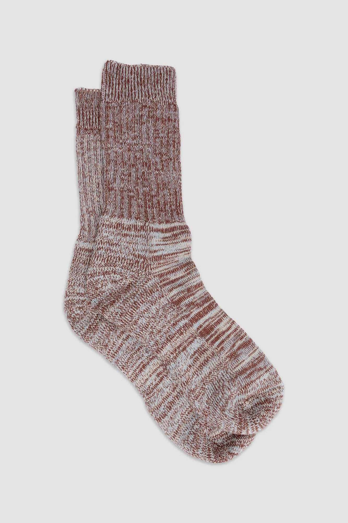 Pair of marled brown socks on a light gray background