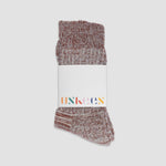 Pair of maroon socks with a white label on a light gray background