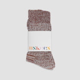 Pair of maroon socks with a white label on a light gray background