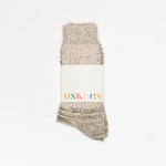 Beige textured sock with a white label on a white background