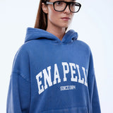 Person wearing a blue hoodie with 'ENAPELLY' branding on a white background