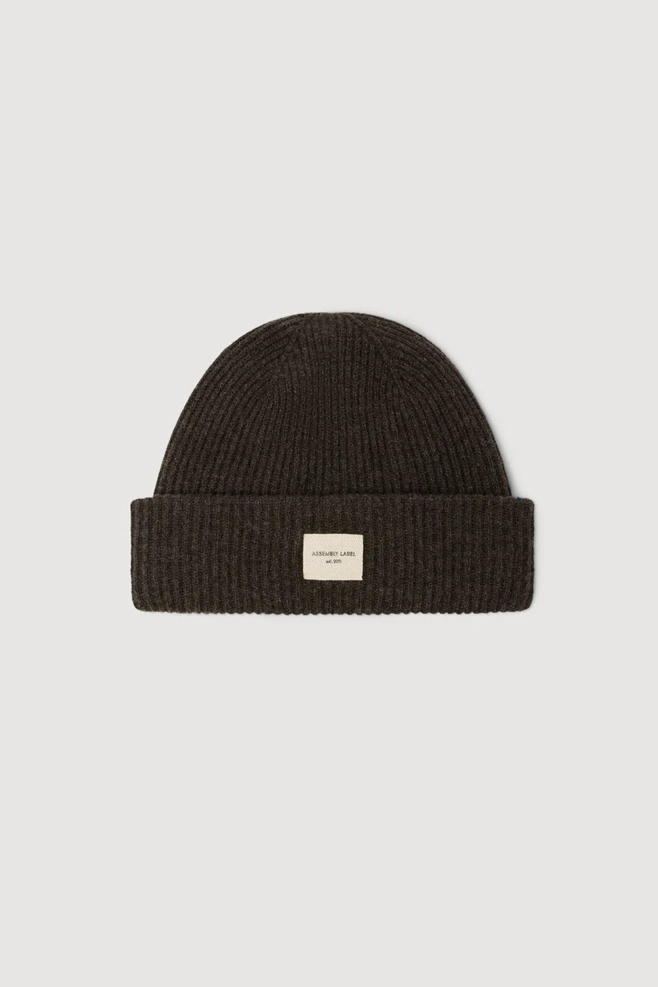 Ganache knit beanie with a small label on a light gray background