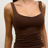 Brown tank top worn by a person on a white background