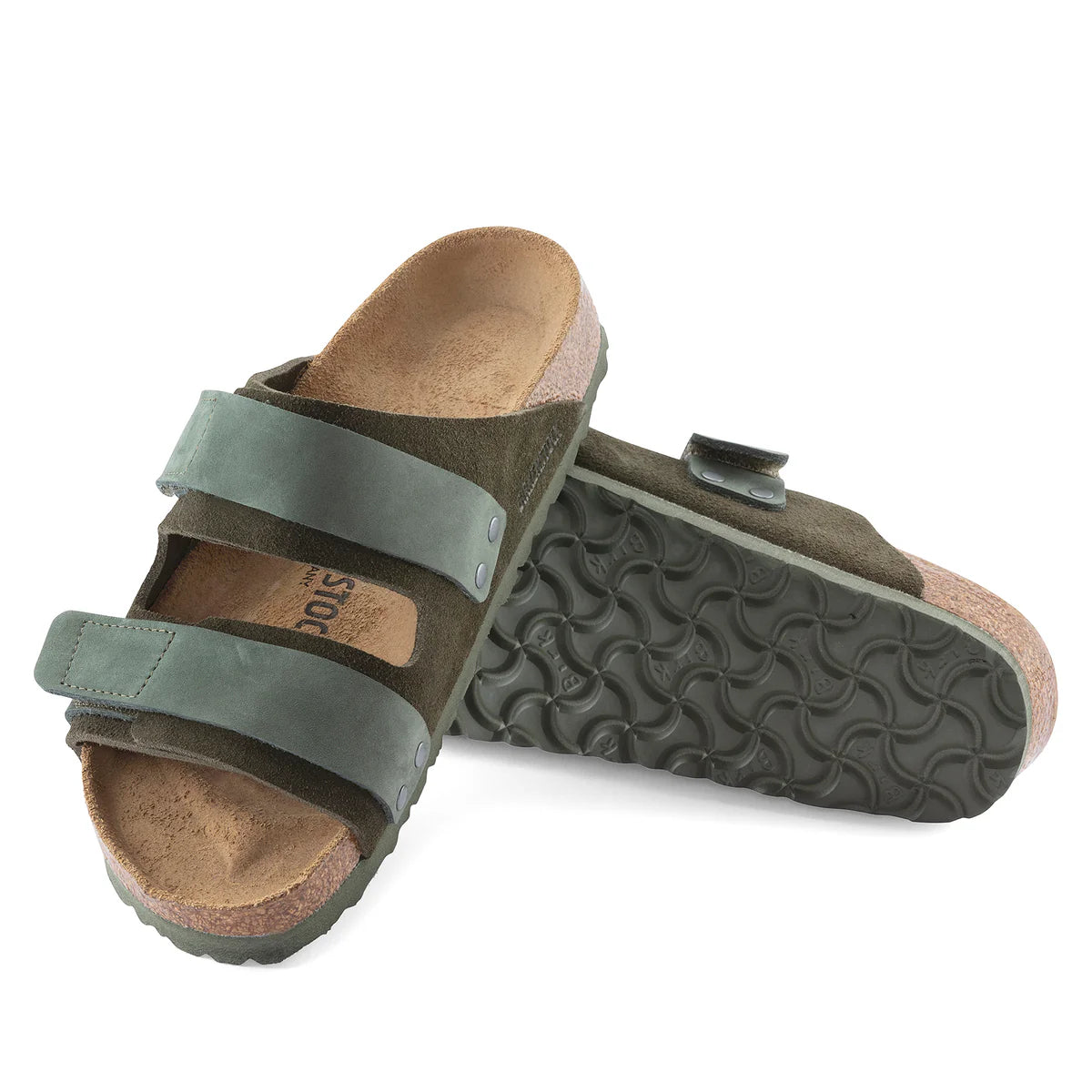 Pair of green sandals with cork feet and textured sole on a white background