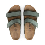 Pair of brown sandals with green straps on a white background