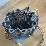 Textured handbag with a unique design on a wooden surface
