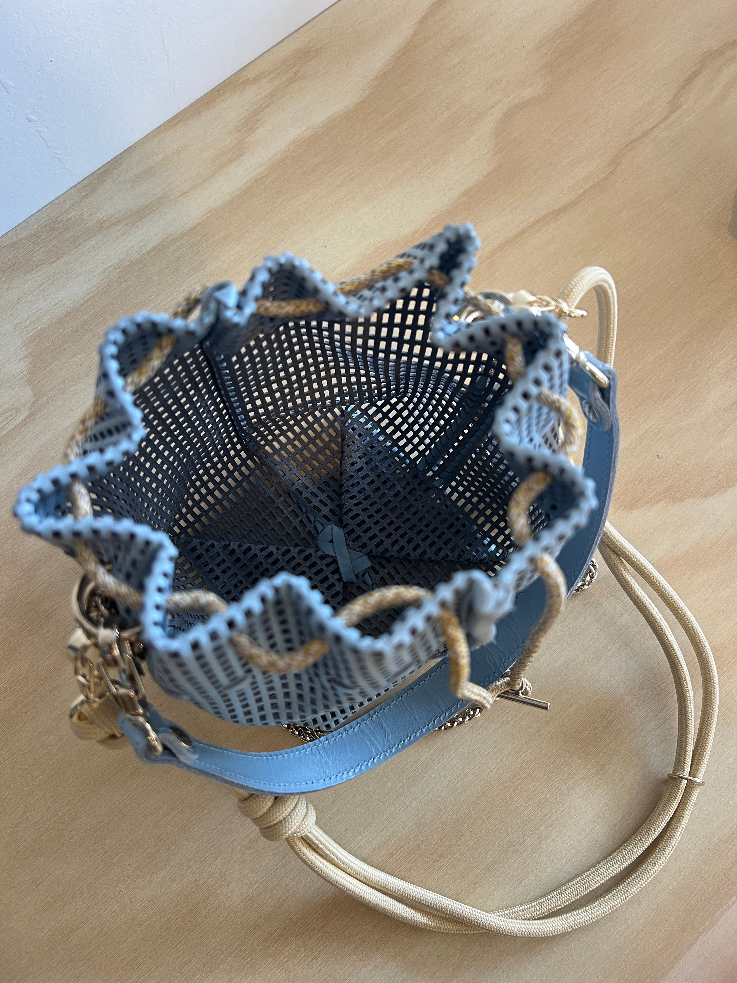 Textured handbag with a unique design on a wooden surface