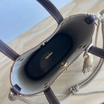 inside of a brown leather bag on a wooden surface