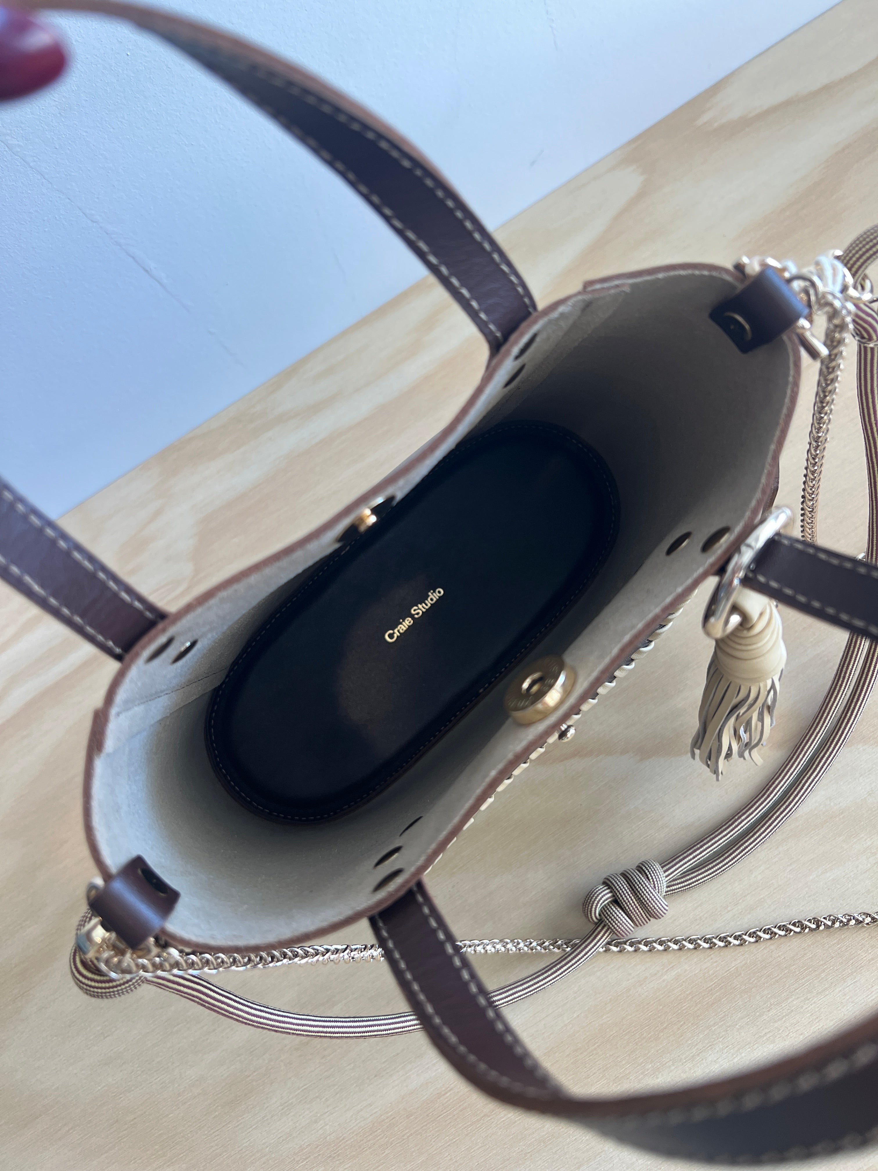 inside of a brown leather bag on a wooden surface