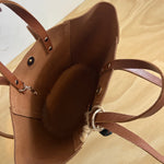 The inside of a tan brown craie studio leather handbag