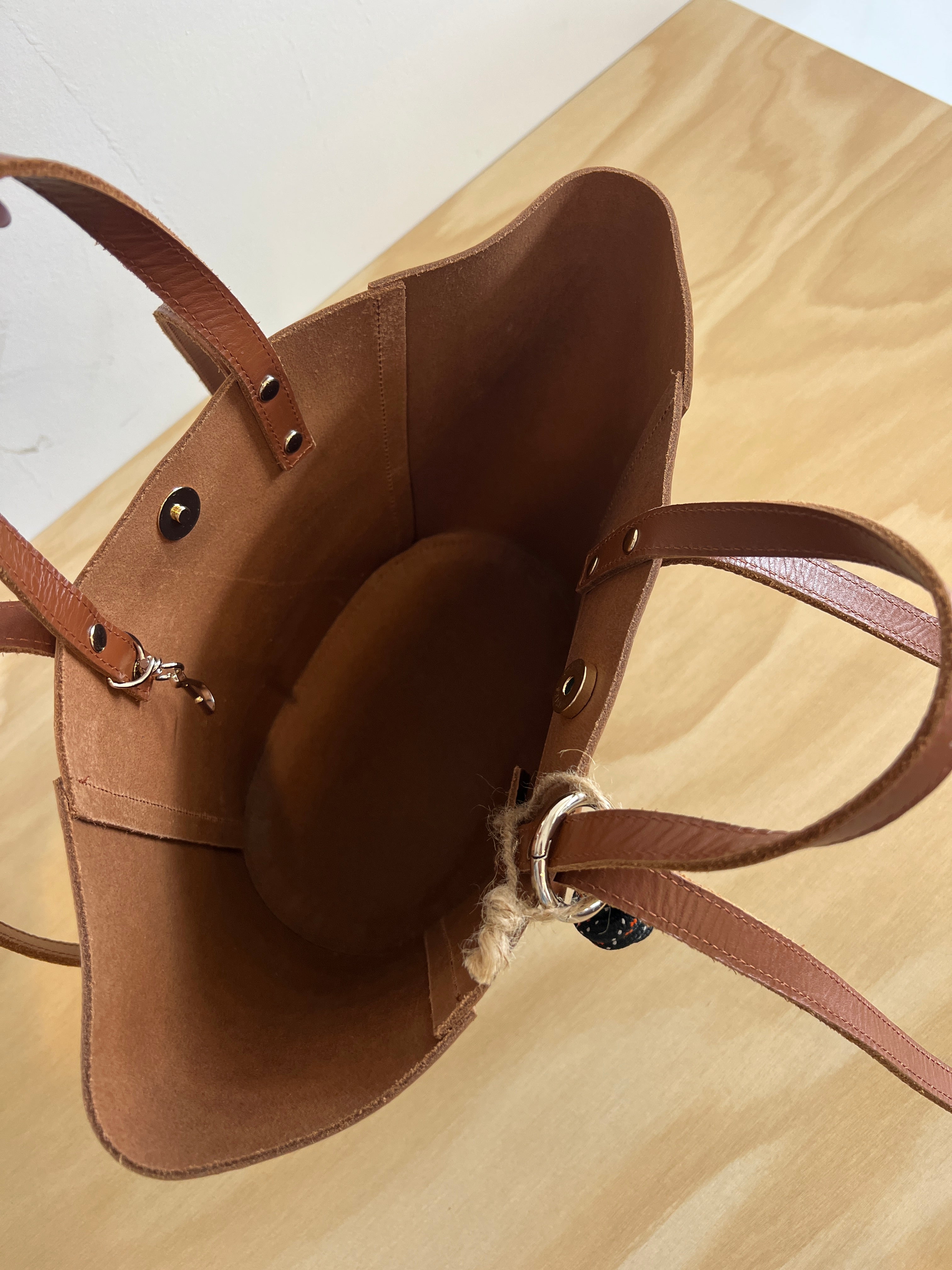 The inside of a tan brown craie studio leather handbag
