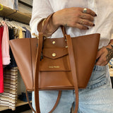 Tan brown handbag held by a person 