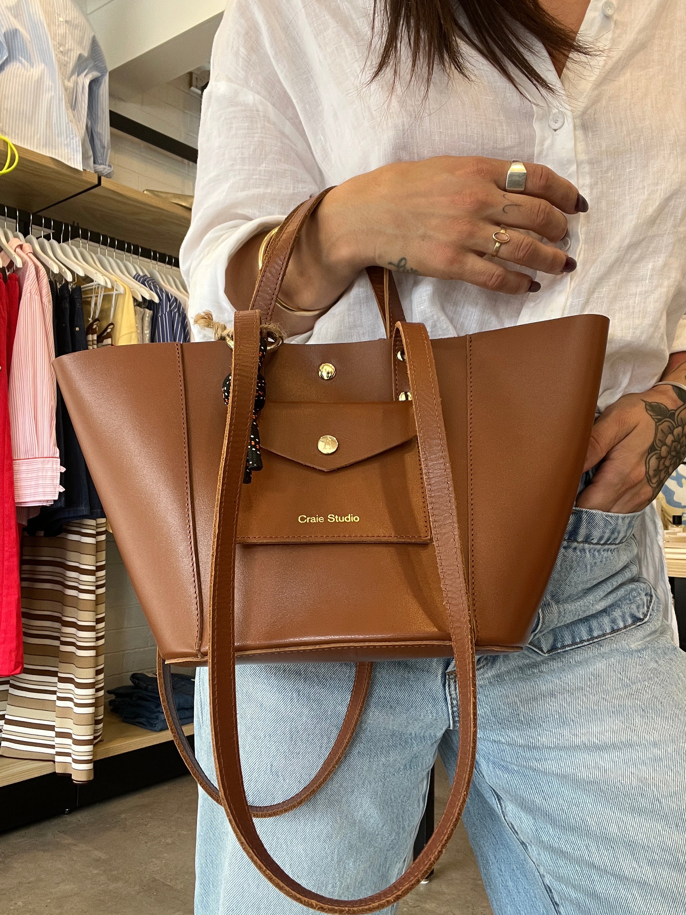 Tan brown handbag held by a person 