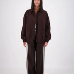 Person wearing a brown outfit on a white background