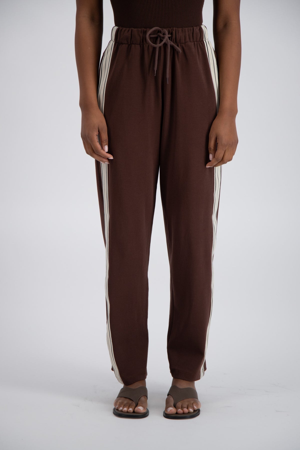 close up detail of brown trackpants.