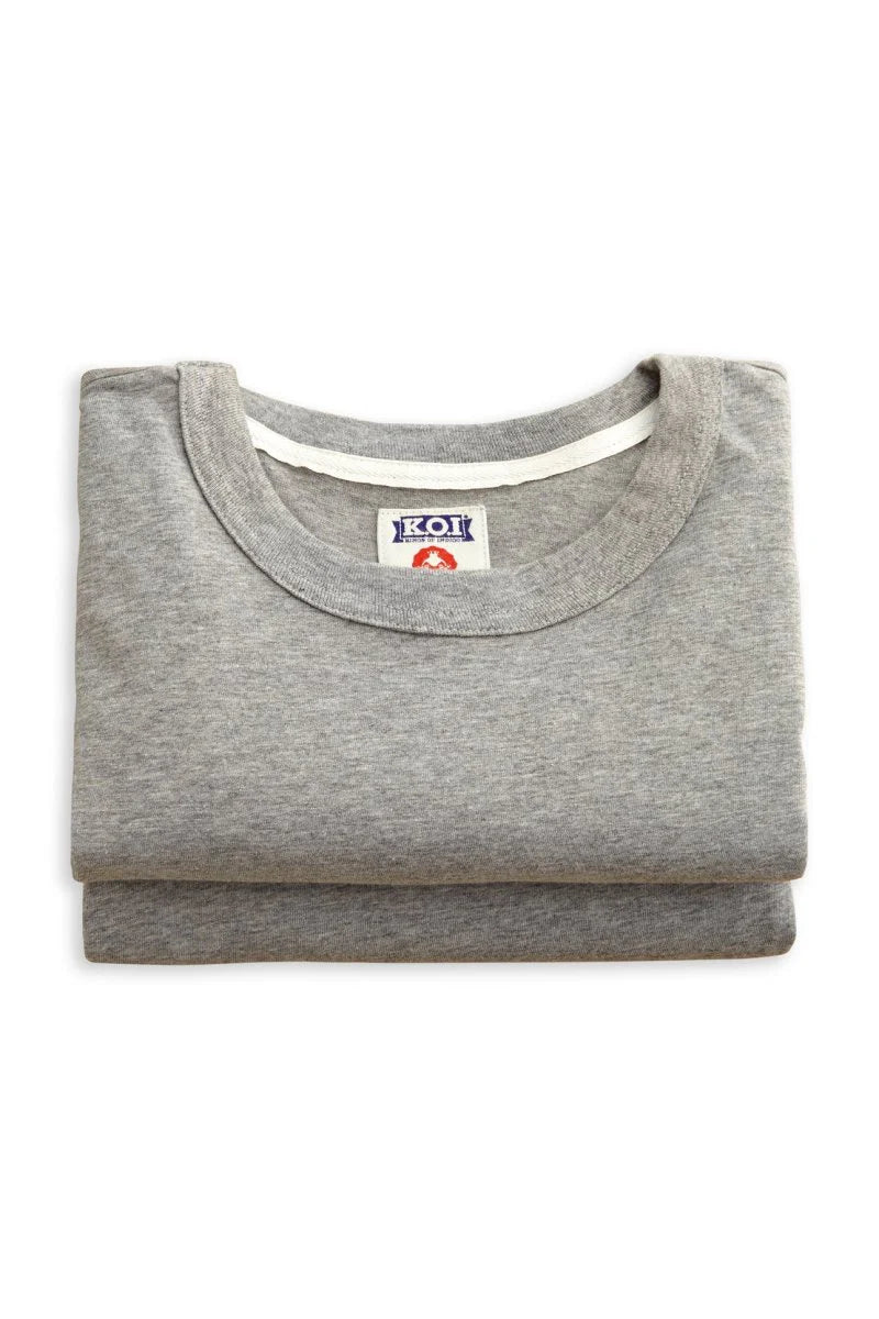 Folded gray shirt with a brand label on a white background