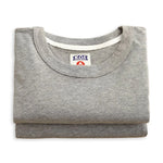 Folded gray shirt with a brand label on a white background