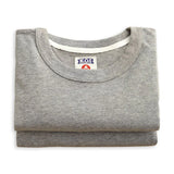 Folded gray shirt with a brand label on a white background