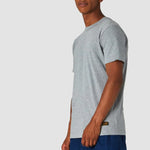 Man wearing a gray t-shirt and blue shorts on a white background