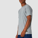Man wearing a gray t-shirt and blue shorts on a white background