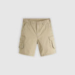 A pair of beige cargo shorts with side flap pockets, shown flat against a light gray background.