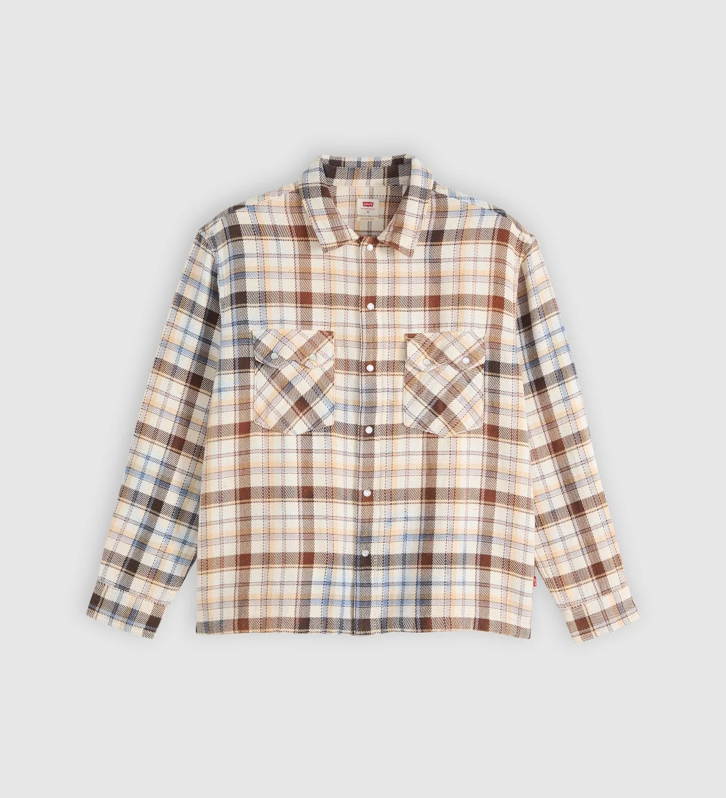 A long-sleeve plaid button-up shirt in beige, brown, and blue tones, laid flat against a light gray background.