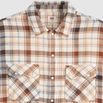 A close-up of a Levi's men's long-sleeve plaid button-down shirt. The fabric features a warm beige base with brown, black, and light blue plaid lines.