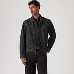 Man wearing a dark denim jacket and jeans on a white background