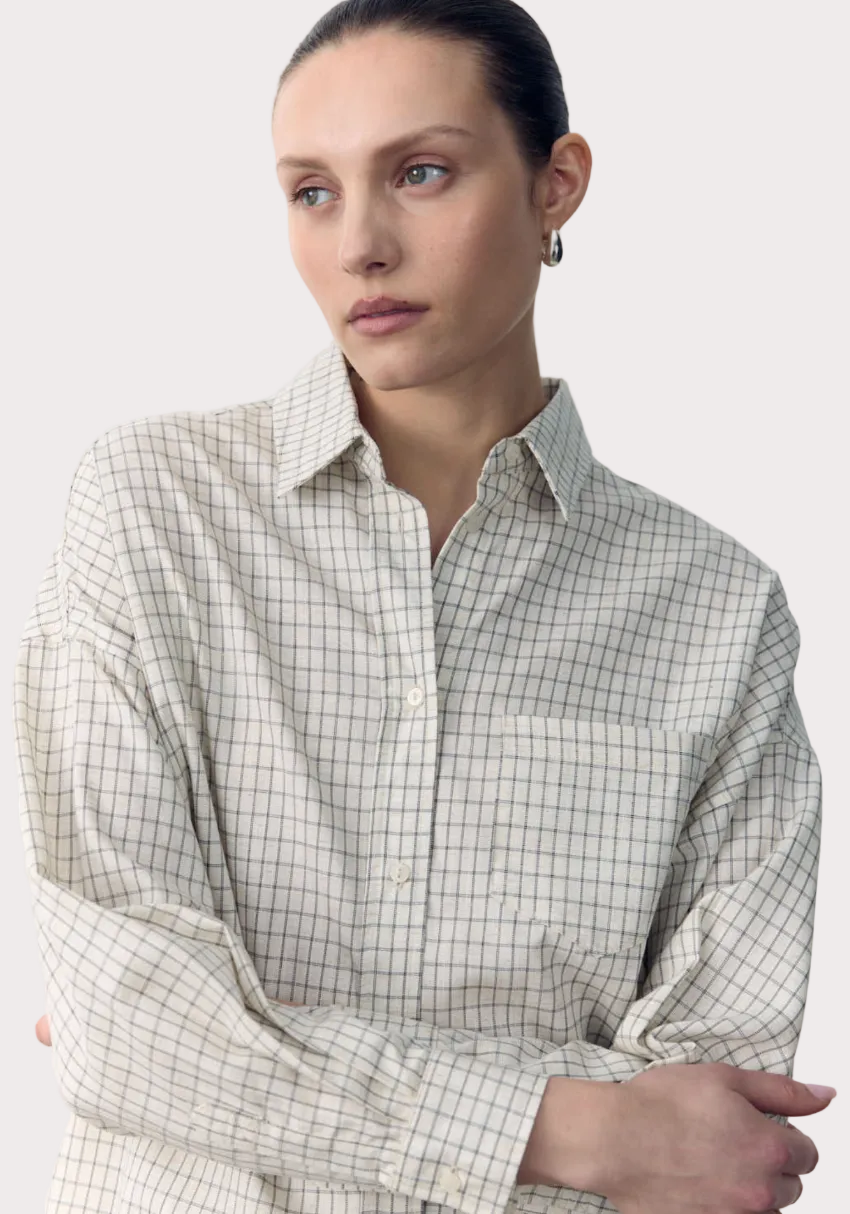 Woman wearing a checkered shirt with text overlay on a white background