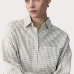 Woman wearing a checkered shirt with text overlay on a white background