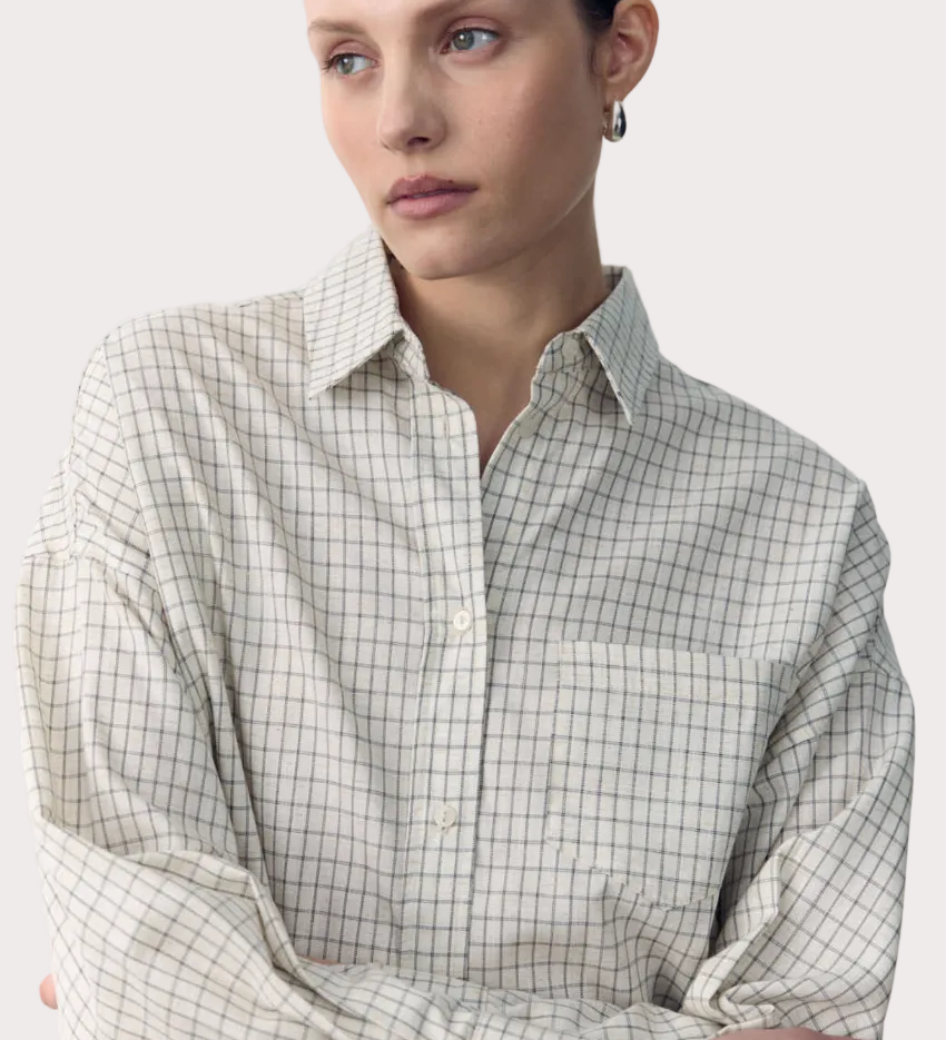 Woman wearing a checkered shirt with text overlay on a white background