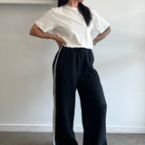 Person lying on a white surface with a minimalistic background