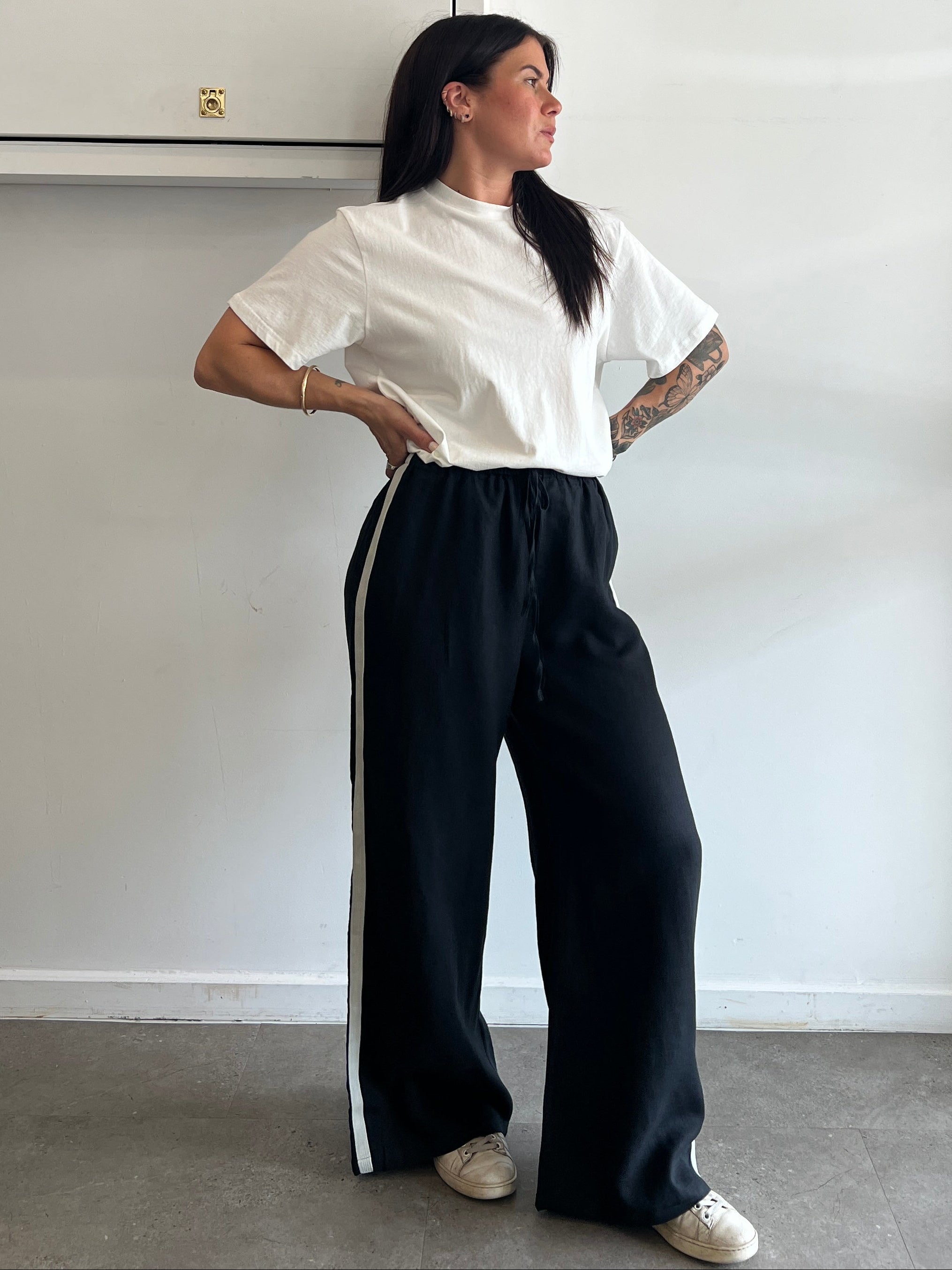 Person lying on a white surface with a minimalistic background