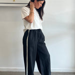 Person lying on a white surface with a neutral background