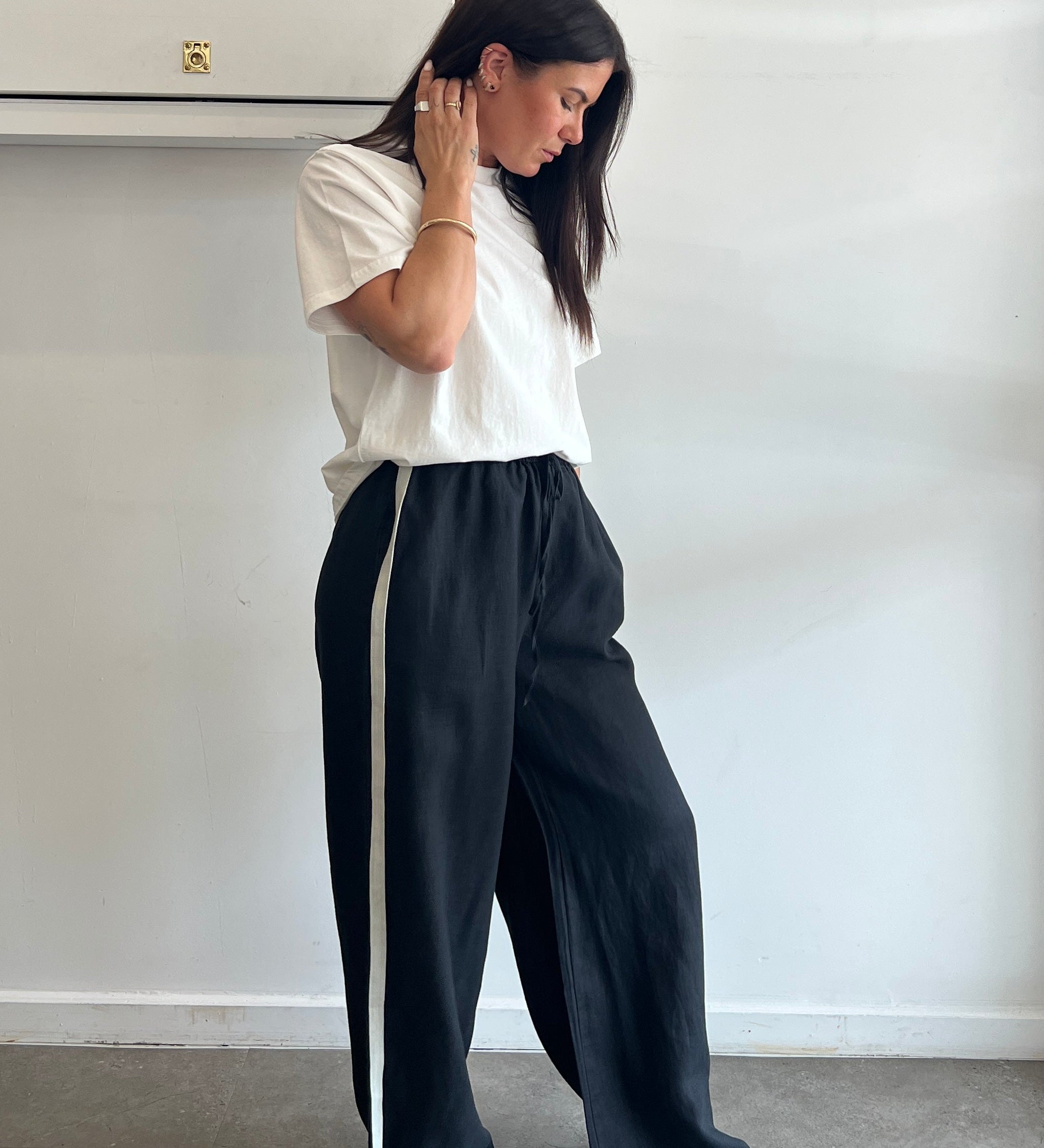 Person lying on a white surface with a neutral background