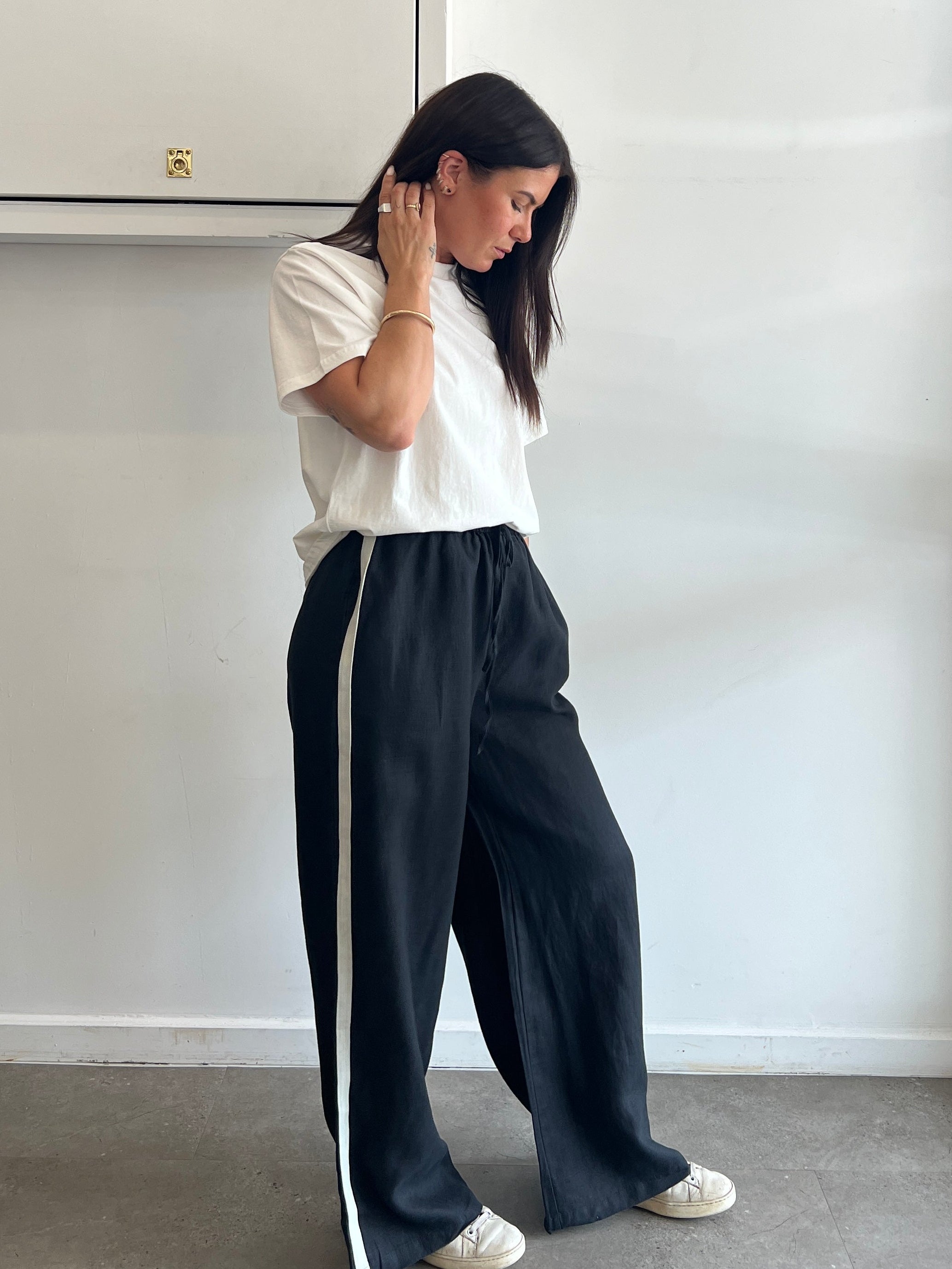 Person lying on a white surface with a neutral background