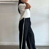 Person lying on a white surface with a neutral background