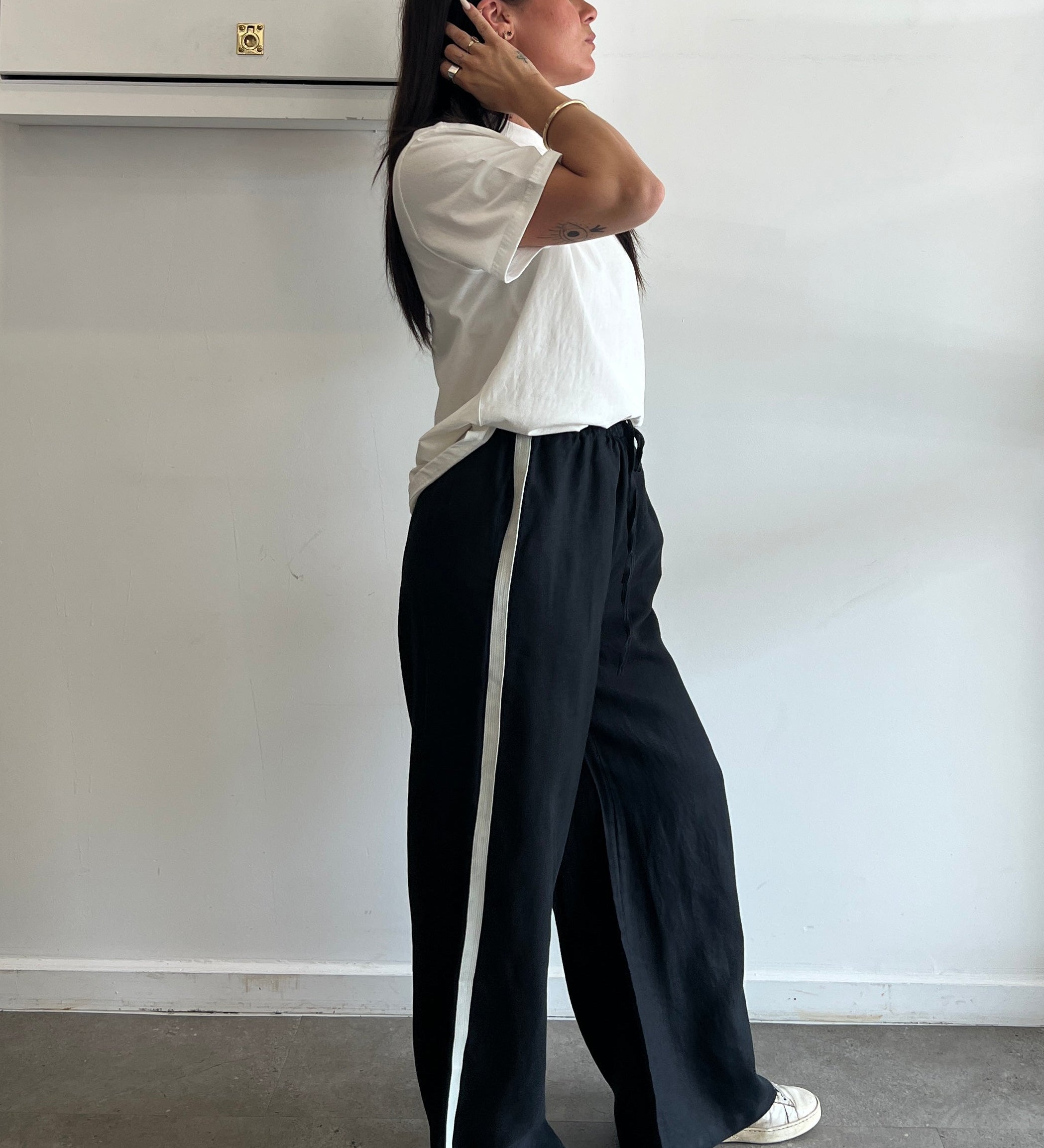 Person lying on a white surface with a neutral background