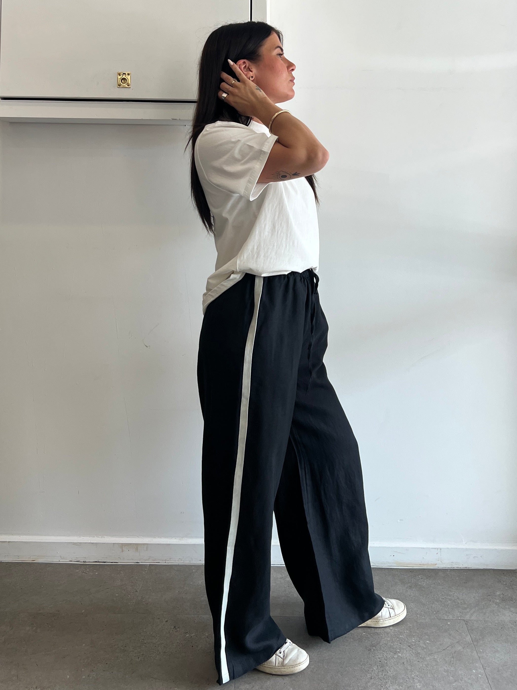 Person lying on a white surface with a neutral background