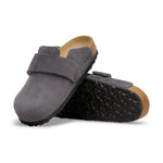 A pair of dark gray suede clogs with a black treaded sole and a natural cork back, displayed on a clean white background.