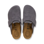A pair of gray suede slip-on clogs with tan Birkenstock footbeds, shown from a top-down view on a white background.