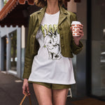 Woman in a casual outfit with a graphic t-shirt and shorts, holding a coffee cup.
