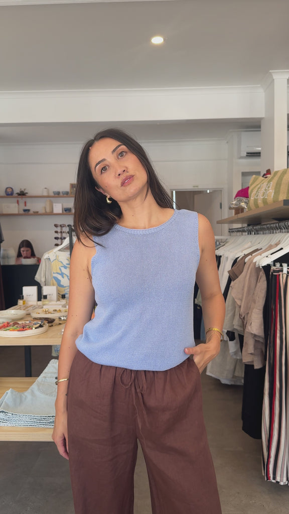 Women Modelling Blue tank top and brown pants