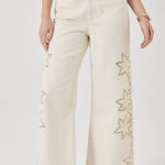 Beige wide-leg pants with floral embroidery on a white background
