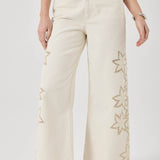 Beige wide-leg pants with floral embroidery on a white background