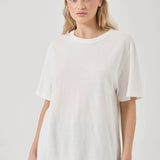 Woman wearing a white t-shirt against a plain background